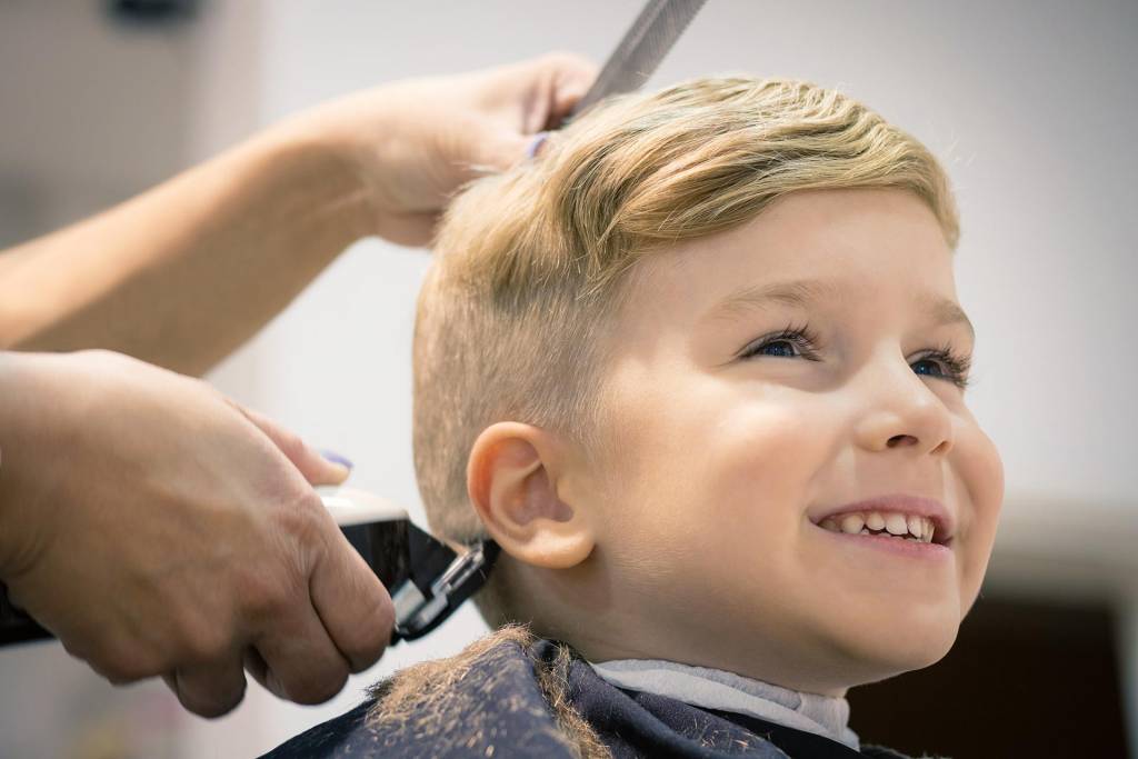 boy-short-blonde-hair-being-cut-with-boy-smiling-in-chair