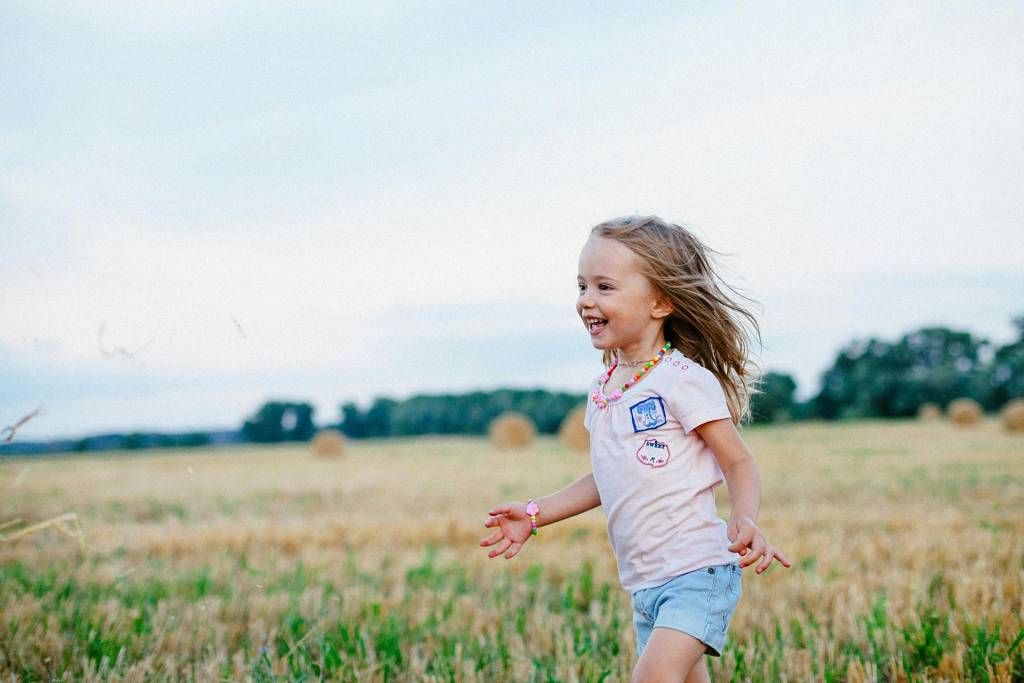 little-blonde-girl-running-through-field-with-fresh-haircut-1920x1280